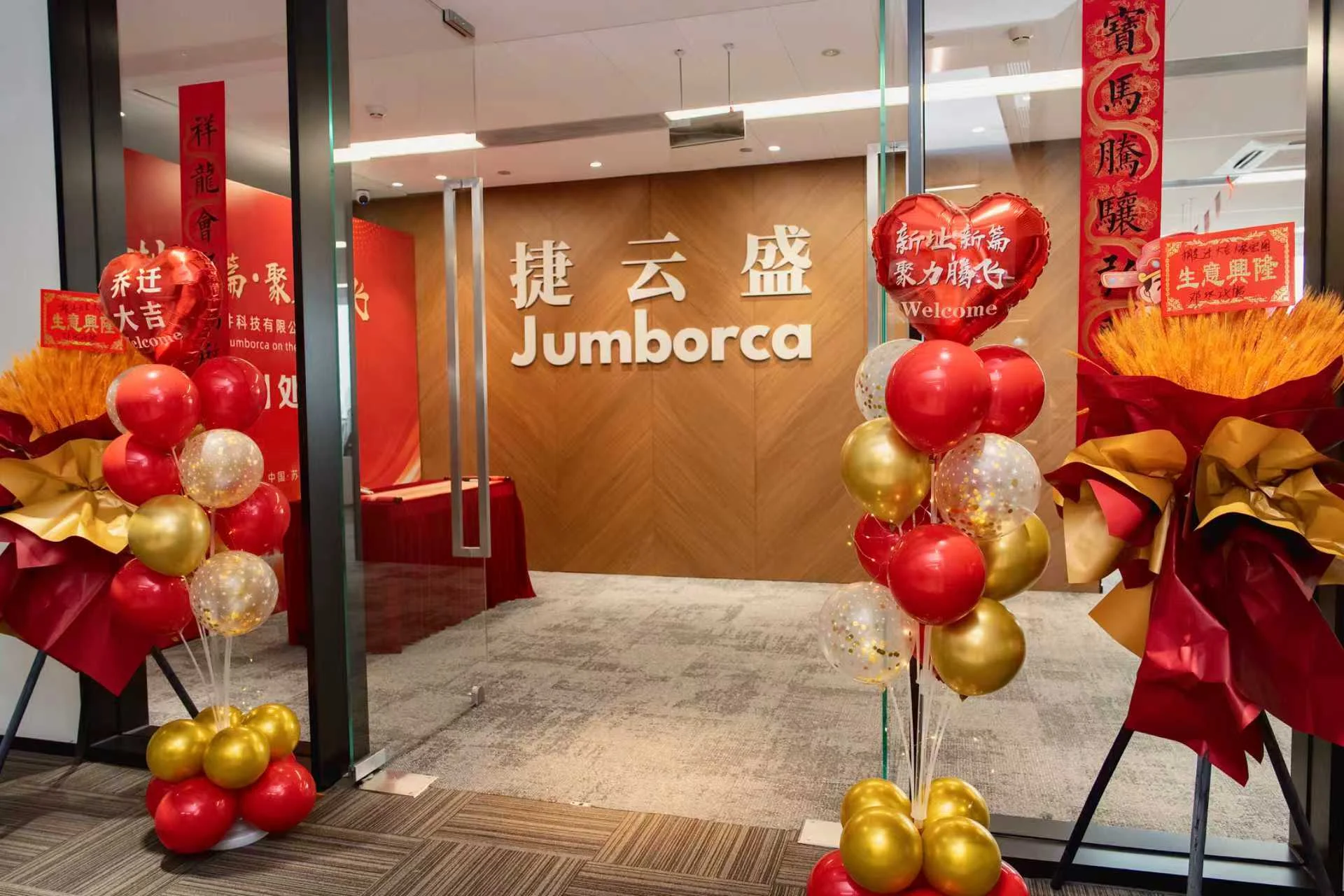 捷云盛苏州总部前台，木饰面墙上的「捷云盛 Jumborca」字样。