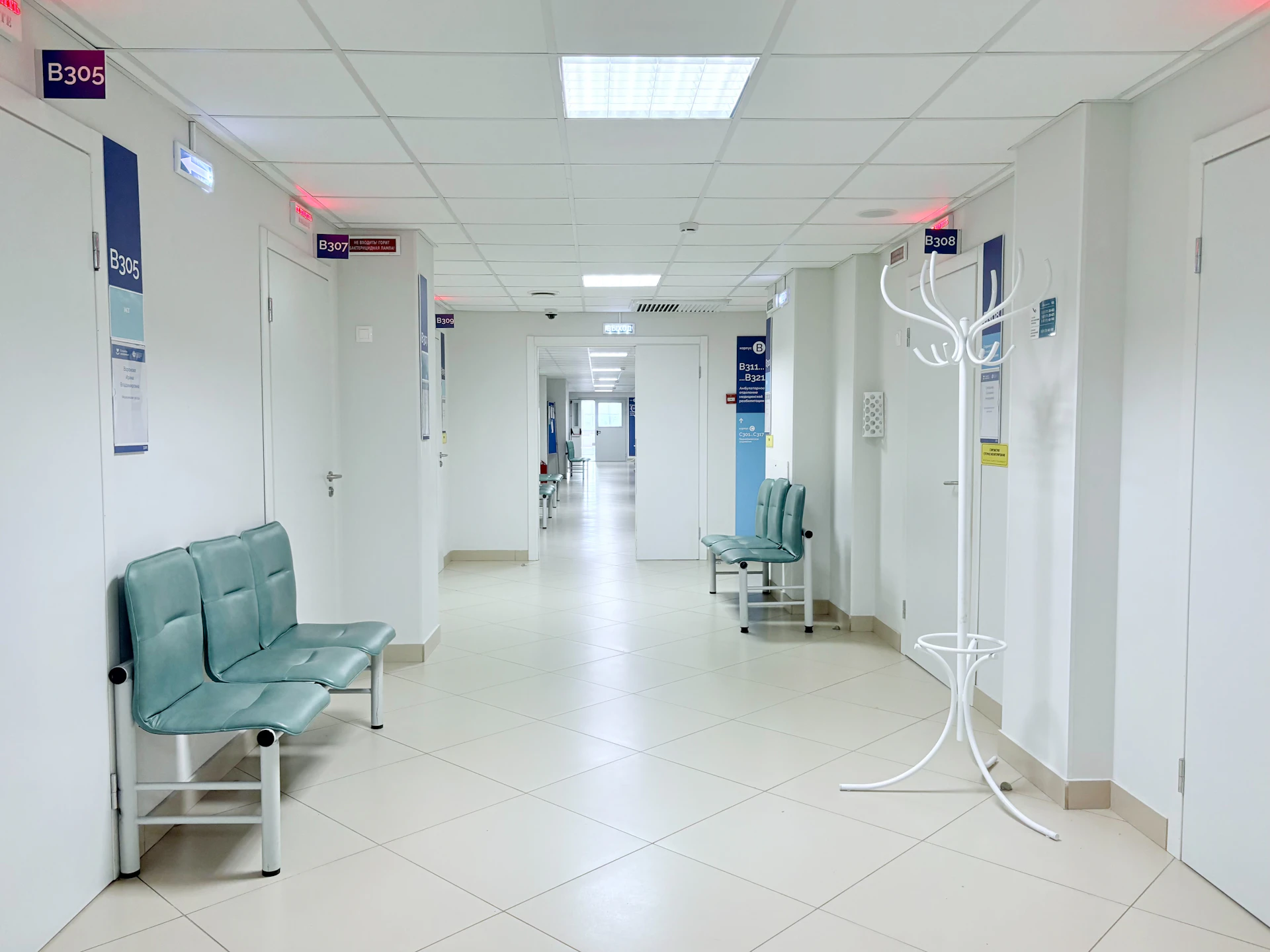 An empty hospital corridor with waiting benches